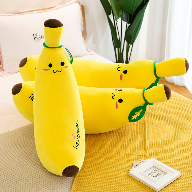 Banana Plush Pillow displayed on a bed, adding a playful touch to a cozy bedroom setting