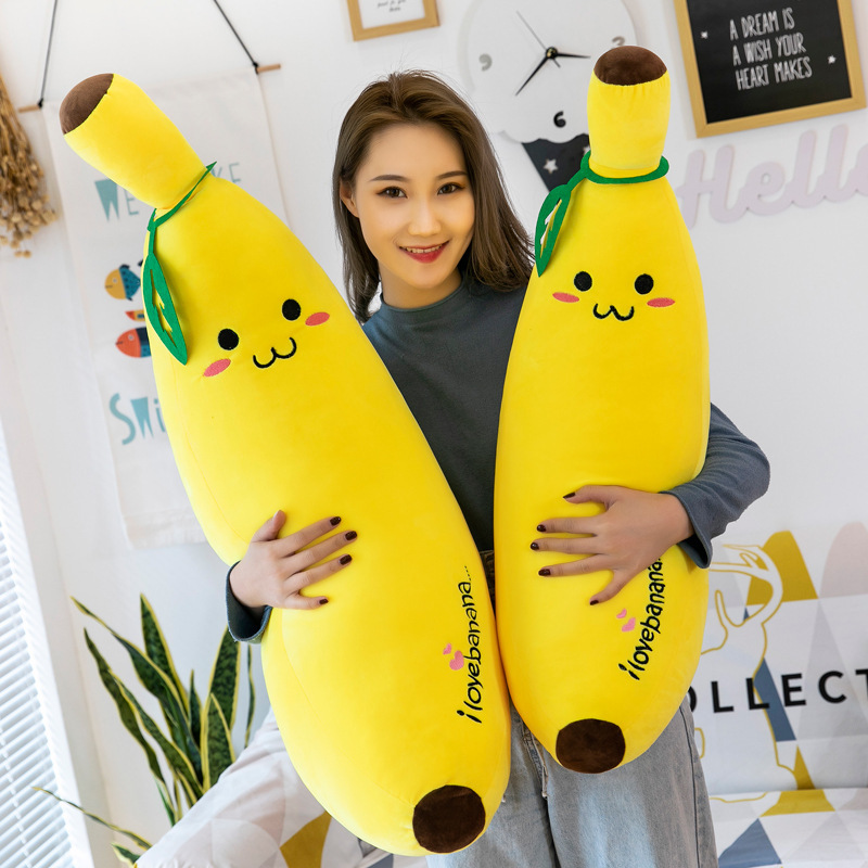Banana Plush Pillow displayed in a cozy bedroom, showcasing its long shape and soft plush design