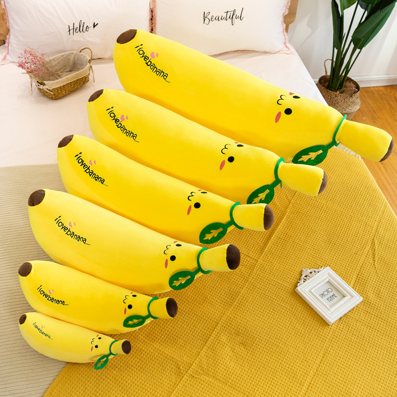 Banana Plush Pillow in multiple sizes arranged on a bed, highlighting size options and cozy home decor appeal