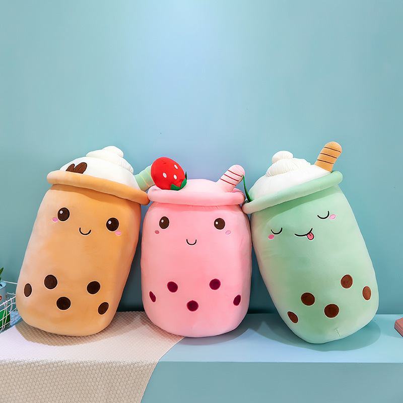 Ice cream bubble tea plush pillows displayed side by side, showcasing different colors, dessert-inspired details, and soft plush construction
