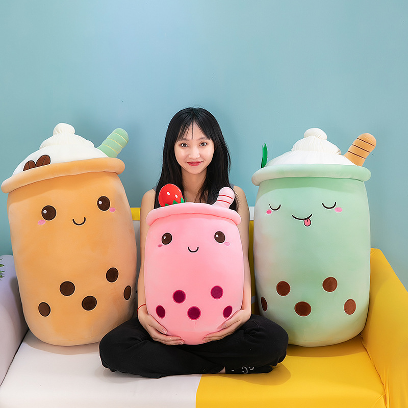 Ice cream bubble tea plush pillows in milk tea, strawberry, and matcha-inspired designs with soft plush fabric and embroidered boba pearl details