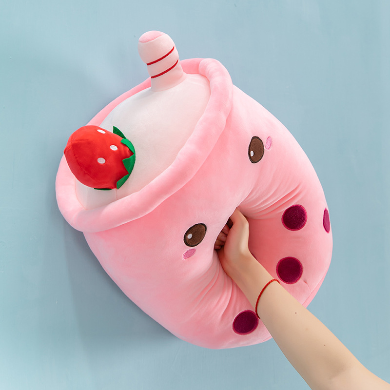 Pink ice cream bubble tea plush pillow showing its soft plush fabric and squeezable filling, with embroidered boba pearl details and dessert-inspired accents