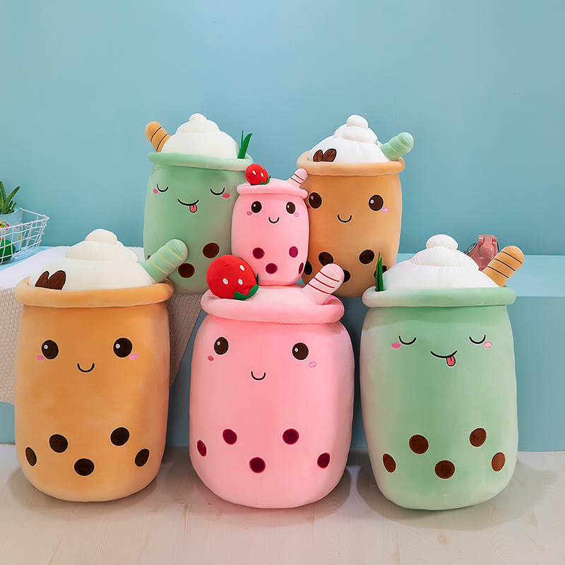 Ice cream bubble tea plush pillows in pink, green, and brown designs, featuring embroidered boba pearls, whipped cream toppings, and cheerful facial expressions