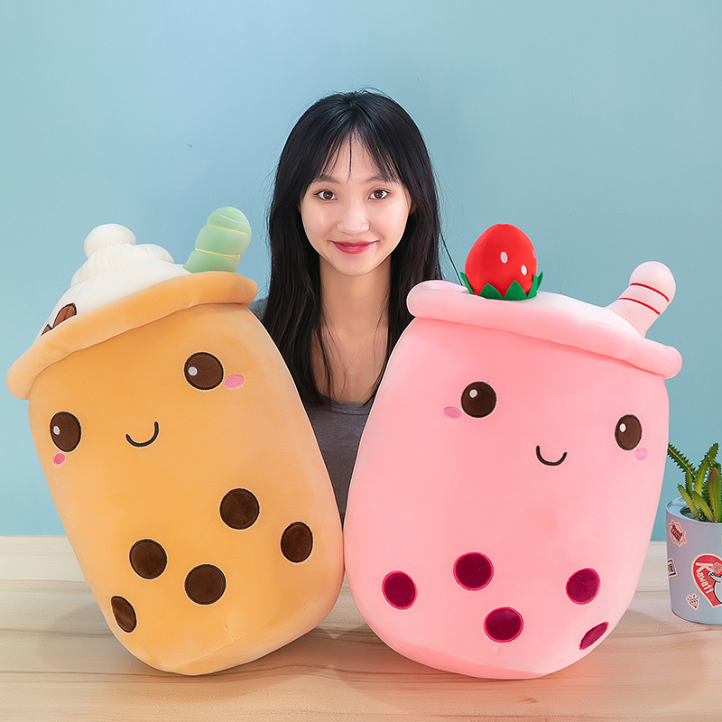 Pink and brown ice cream bubble tea plush pillows with cheerful embroidered faces, whipped cream tops, and soft rounded shapes