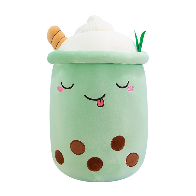 Green ice cream bubble tea plush pillow with a playful embroidered expression, whipped cream top, and soft cuddly design