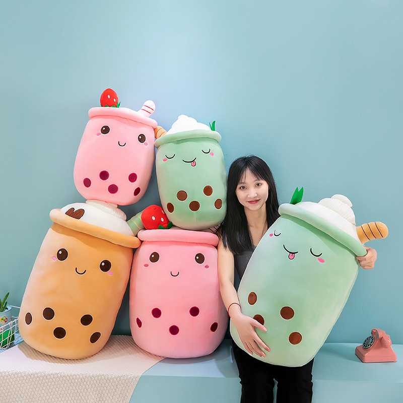 Ice cream bubble tea plush pillows in milk tea, strawberry, and matcha-inspired designs with embroidered boba pearls, whipped cream toppings, and soft plush fabric