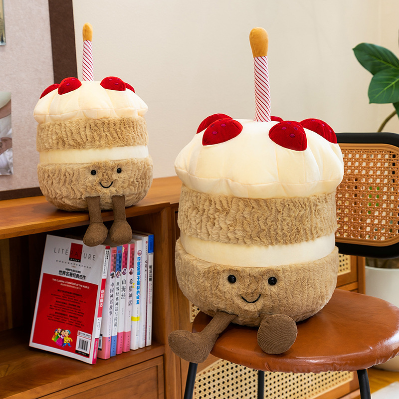 Birthday Cake Plush Toys displayed on a chair and shelf, highlighting soft plush textures, layered cake details, dangling legs, and cozy decorative appeal