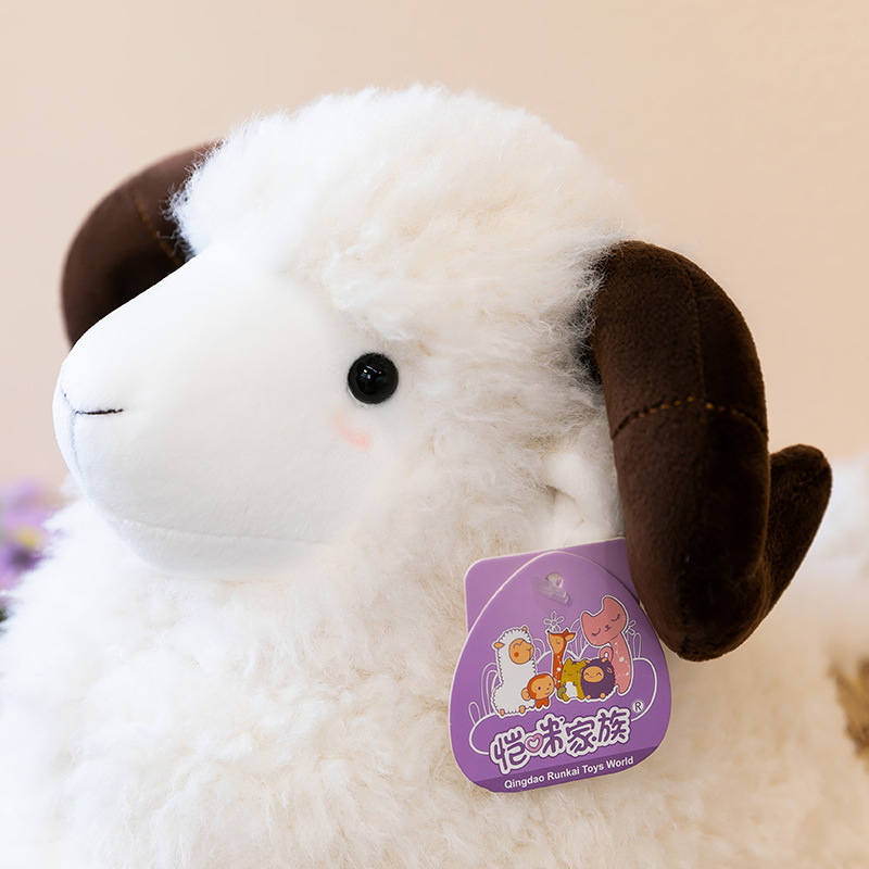 Close-up of White Bighorn Sheep Plush Toy showing soft fluffy fur and curved plush horns
