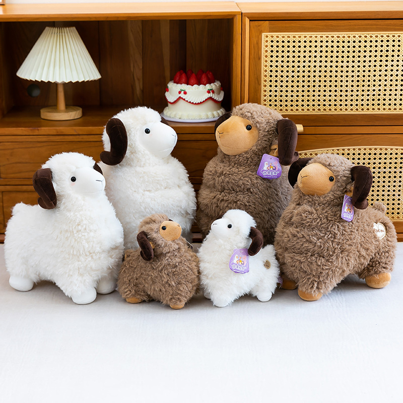 Brown and white Bighorn Sheep Plush Toys in multiple sizes displayed as cozy home decor on a cabinet shelf