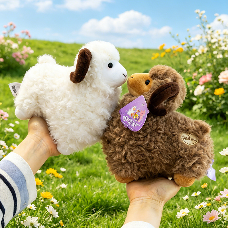 Brown and white Bighorn Sheep Plush Toys with fluffy wool-like texture and curved horns displayed in a sunny meadow