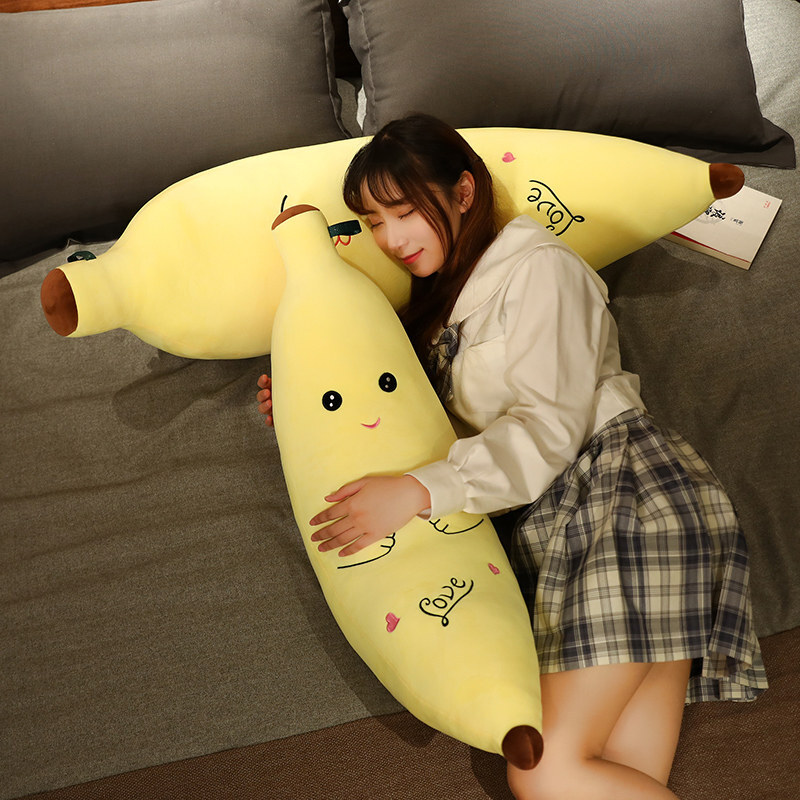 Cute Banana Plush Pillow used as a cozy body pillow on a bed, featuring a soft banana-shaped design for hugging, lounging, and relaxing