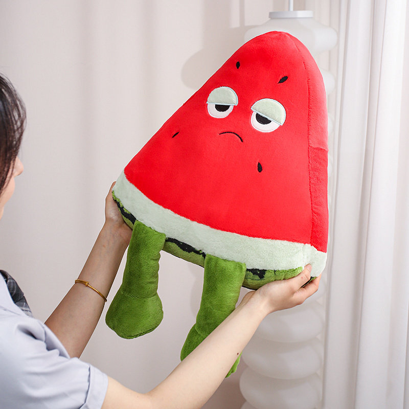 Funny Watermelon Plush Pillow featuring embroidered facial details, vibrant watermelon-inspired colors, and signature dangling legs for a fun decorative touch