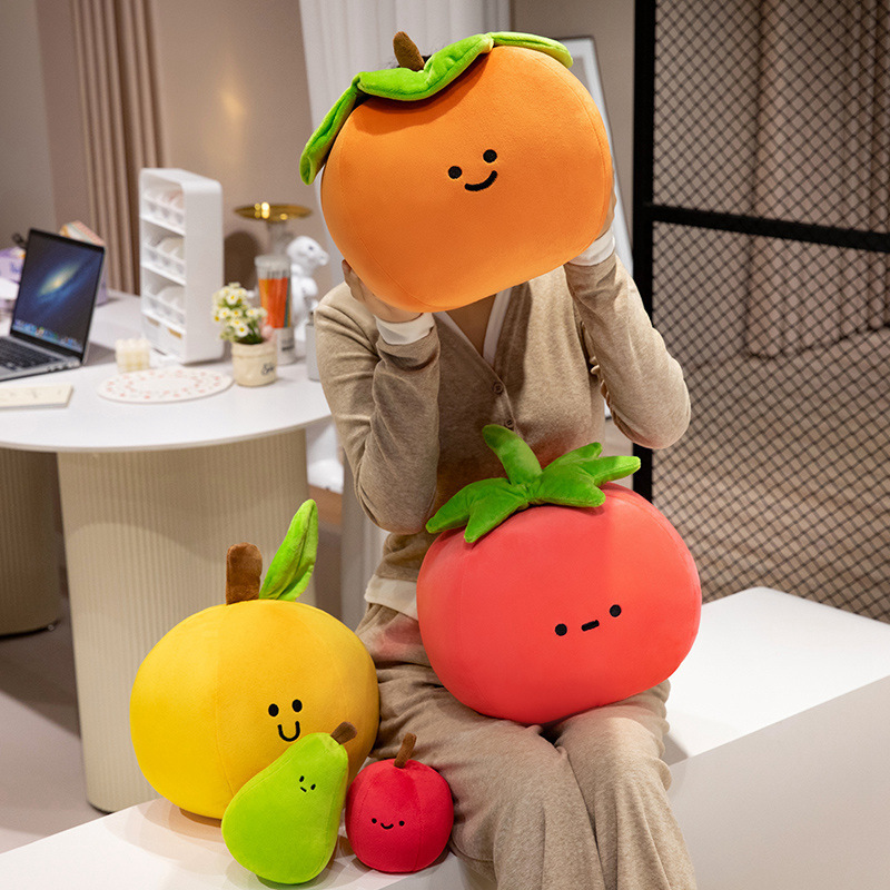 Persimmon, tomato, orange, pear, and apple plush toys arranged together with soft plush textures and playful fruit-inspired designs