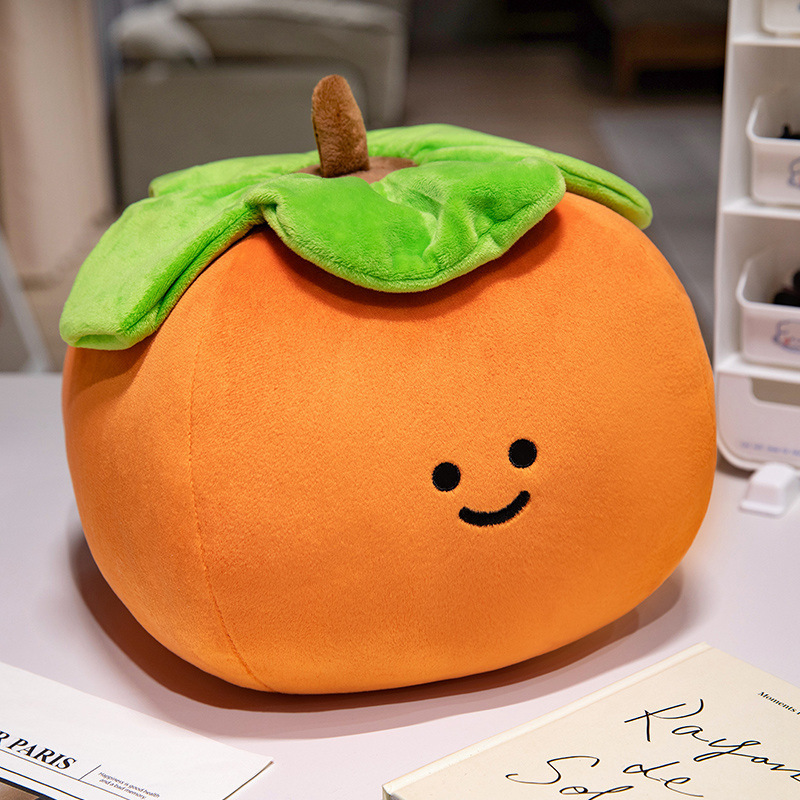Persimmon Fruit Plush Toy with a smiling embroidered face, soft plush fabric, and oversized leaf detail