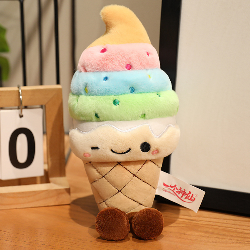 Rainbow Ice Cream Plush Toy with pastel rainbow soft serve layers, embroidered sprinkle details, winking face, and dangling plush legs