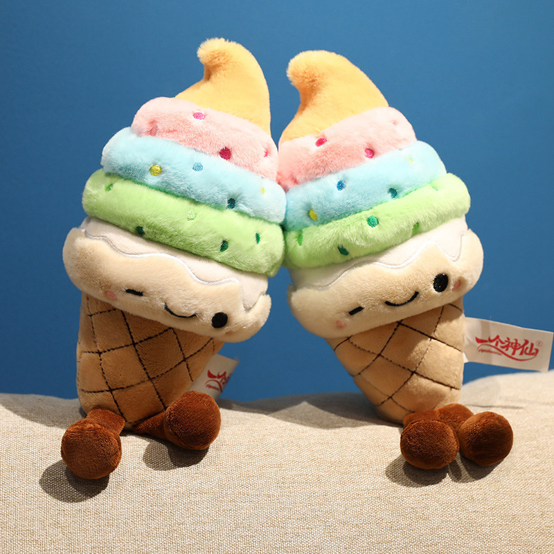 Rainbow Ice Cream Plush Toys featuring pastel rainbow soft serve layers, embroidered winking faces, and dangling legs displayed side by side
