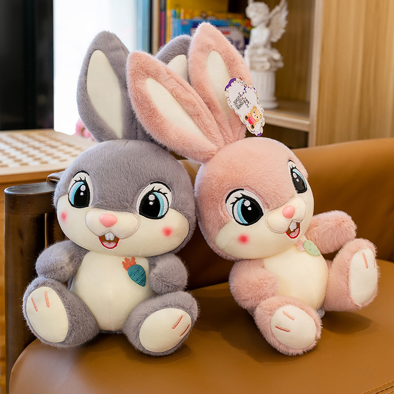 Sweet Bunny plush toys in gray and pink sitting on a chair, featuring long ears, embroidered details, and a cozy decorative look for bedrooms and reading corners