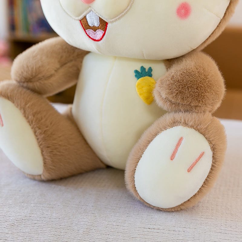 Close-up of the Sweet Bunny Plush Toy body, featuring soft plush fabric, embroidered paw details, and a carrot applique accent