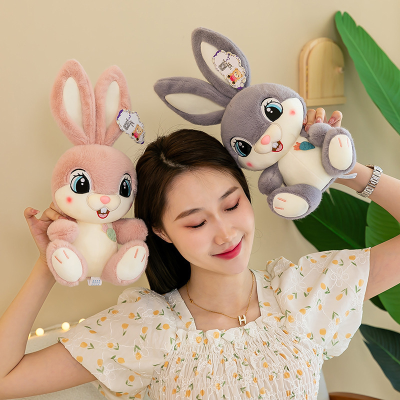 Sweet Bunny plush toys in pink and gray shown as cuddly companions, featuring oversized ears, soft plush fabric, and a playful, cozy bedroom atmosphere