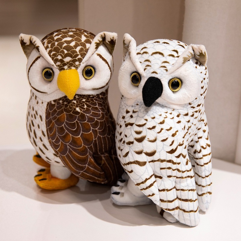 Realistic owl plush toys in brown and white color options displayed on a shelf, featuring detailed feather prints, soft plush fabric, and nature-inspired design