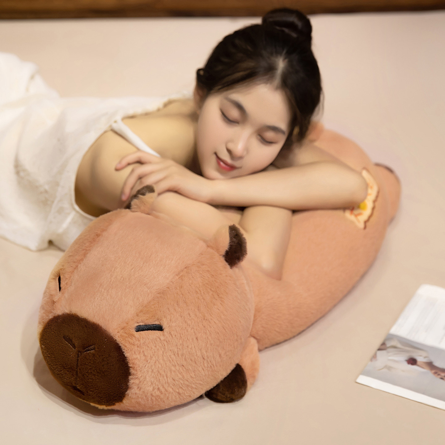 Soft Lucky Capybara plush pillow used as a cuddle pillow while relaxing, featuring a long body design and plush filling for comfort and support