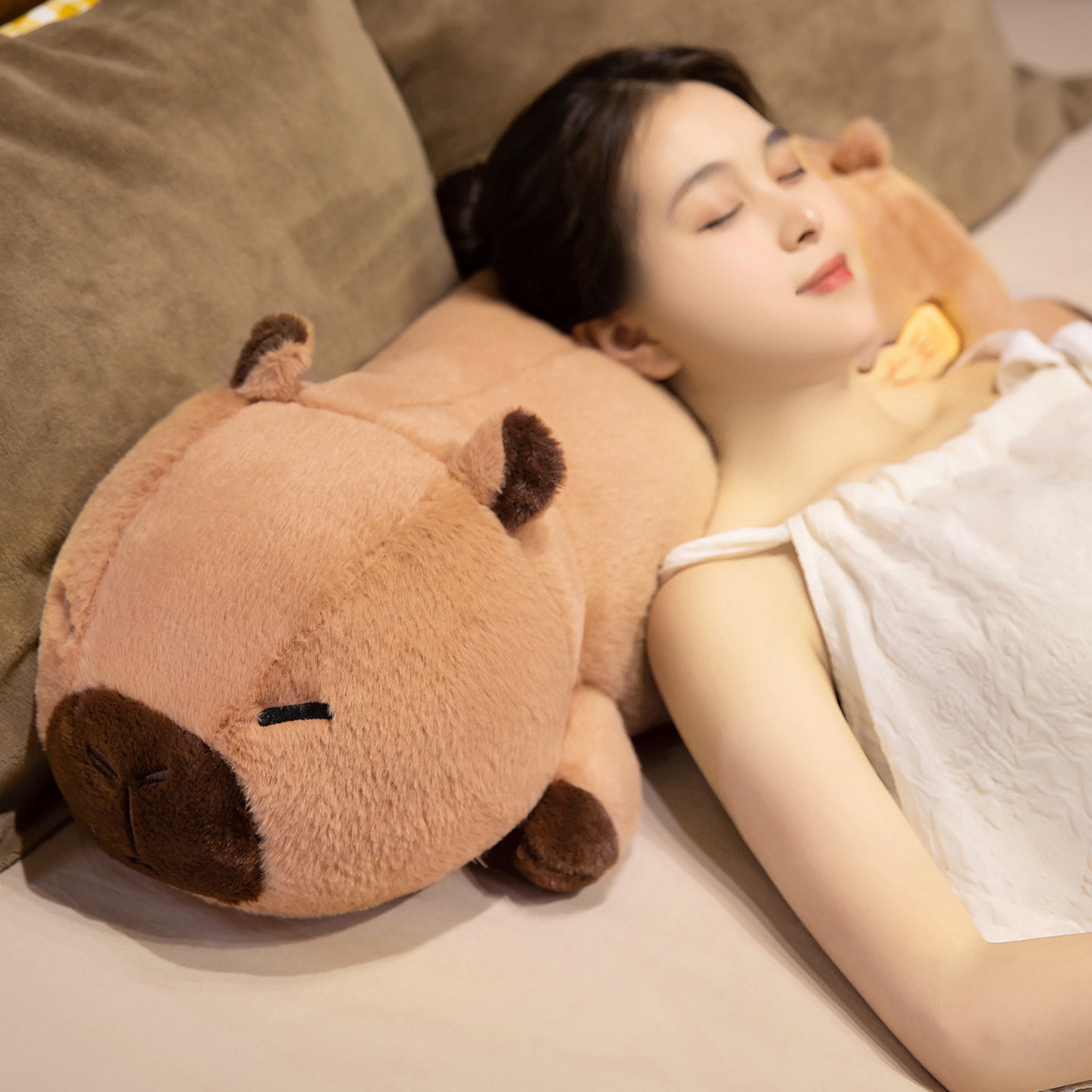 Lucky Capybara plush body pillow used as a soft headrest on a bed, highlighting its cozy plush texture and comfortable design for resting and napping