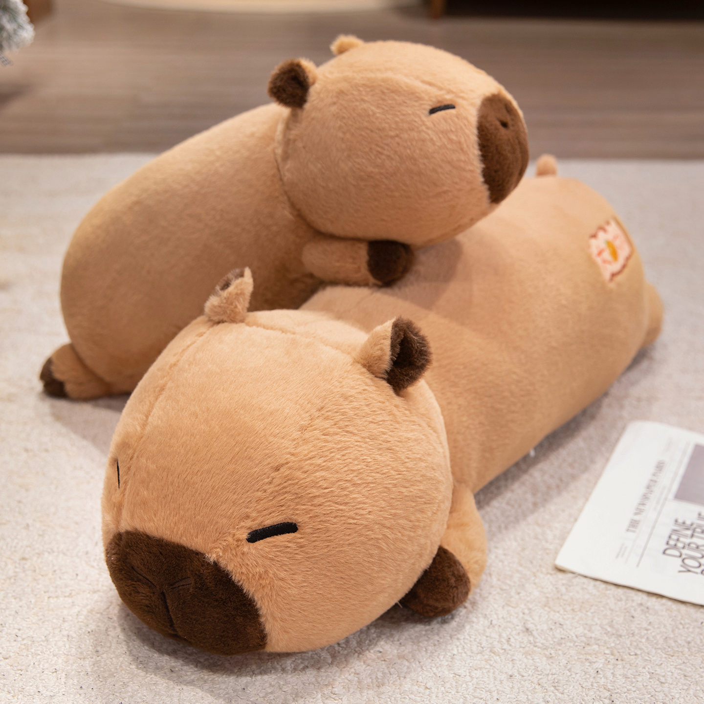 Two Lucky Capybara plush pillows in 60 cm and 80 cm sizes stacked together, featuring a soft elongated body, embroidered lucky detail, and cuddly design for lounging, napping, and cozy home decor