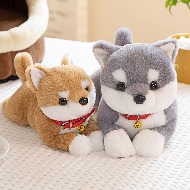 Brown and gray Shiba Inu plush toys displayed on a bed, adding warmth and charm to cozy home decor