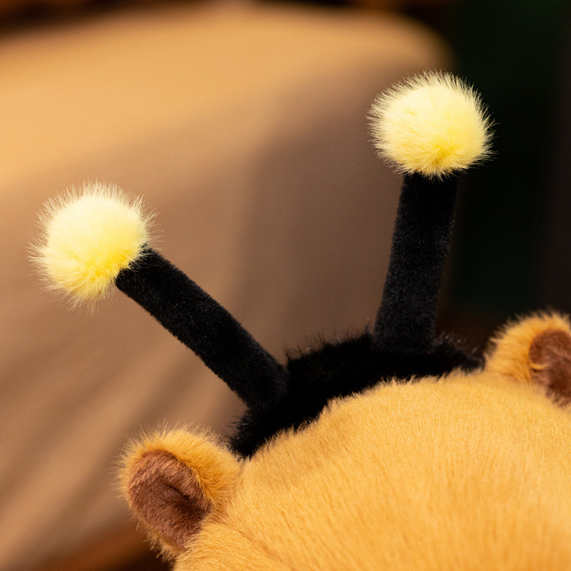 Bee Capybara Plush Toy antenna detail featuring plush texture and fluffy yellow pom-pom ends