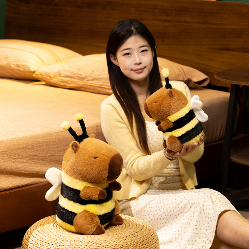 Bee Capybara Plush Toy displayed in a cozy room setting, highlighting its cuddly size and bee-inspired design for decorating bedrooms and reading corners