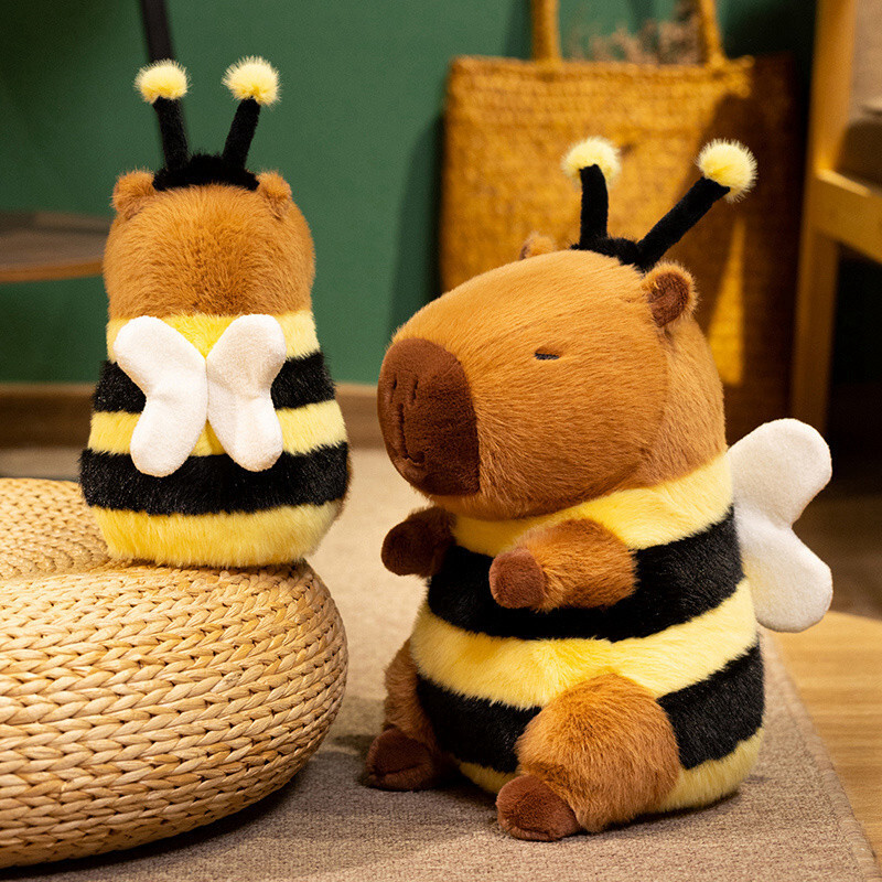Bee Capybara Plush Toy showing front and back views with soft plush wings, fuzzy antennae, black-and-yellow bee stripes, and a cute sleepy capybara design