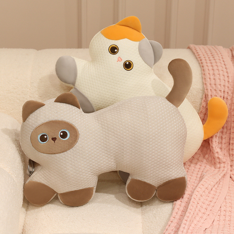 Calico Cat and Siamese Cat cooling plush pillows displayed together on a sofa, featuring adorable cat designs and breathable textured cooling fabric