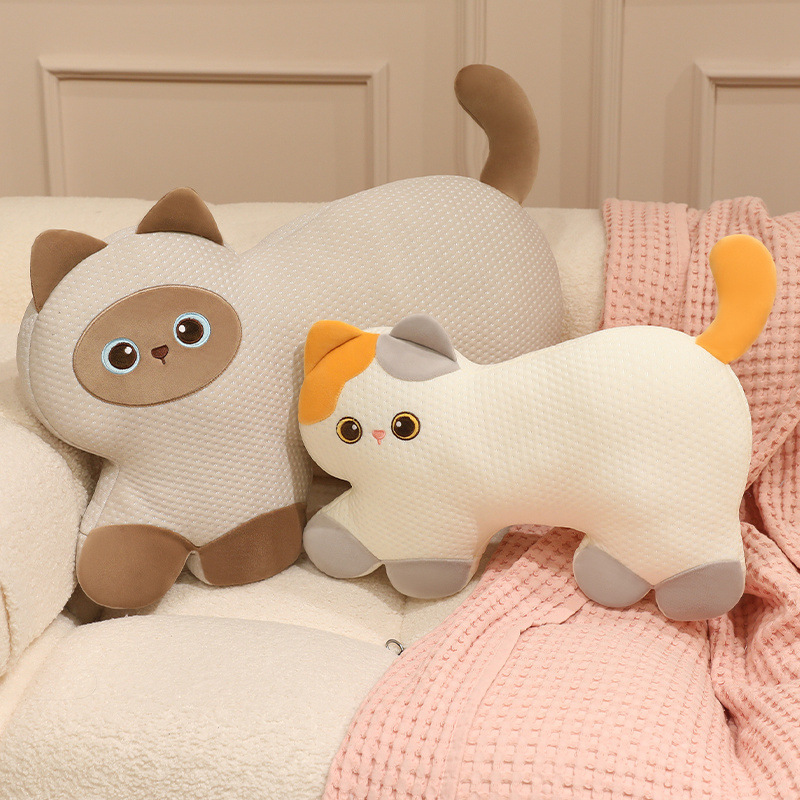 Calico Cat and Siamese Cat cooling plush pillows displayed on a sofa, featuring soft breathable fabric and adorable cat-shaped designs for cozy home decor