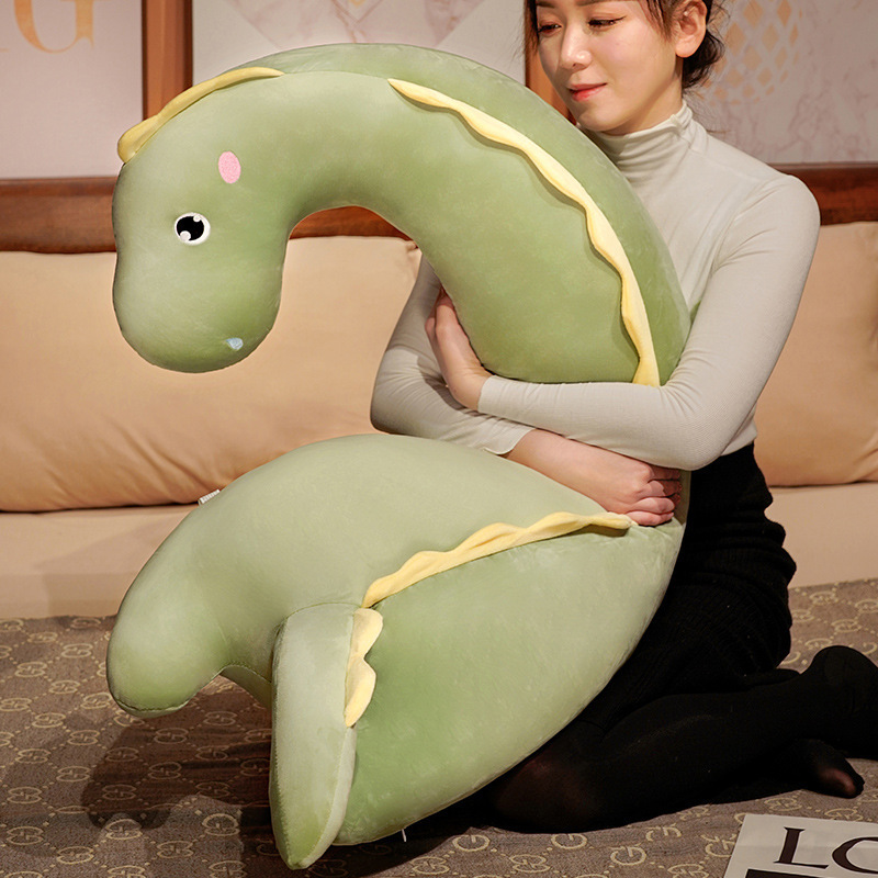 Round Eyes Dinosaur Long Plush Pillow used as a soft hugging body pillow for comfort and relaxation