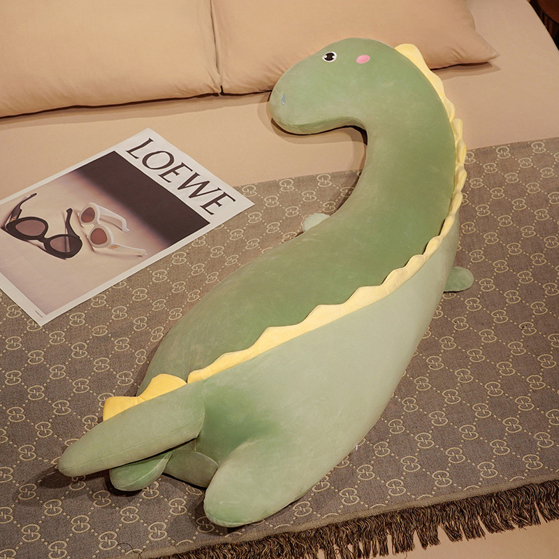 Round Eyes Dinosaur Long Plush Pillow featuring a curved body shape, soft plush fabric, and playful dinosaur details for hugging, lounging, and sleeping
