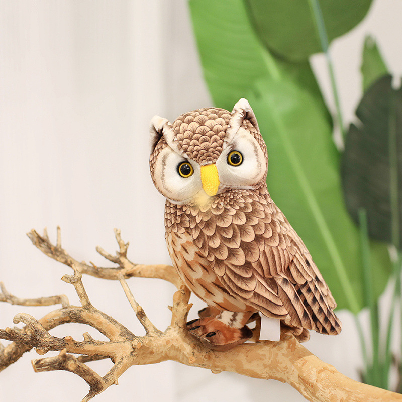 Cute Owl Plush Toy displayed on a rustic branch with realistic feather-inspired printing, bright eyes, and a woodland-inspired display setting