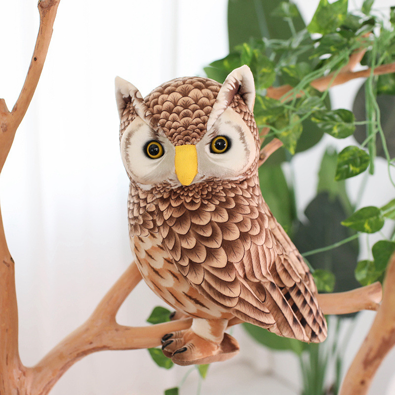 Cute Owl Plush Toy perched on a decorative branch, showcasing realistic feather-inspired details, standing design, and nature-inspired decorative charm