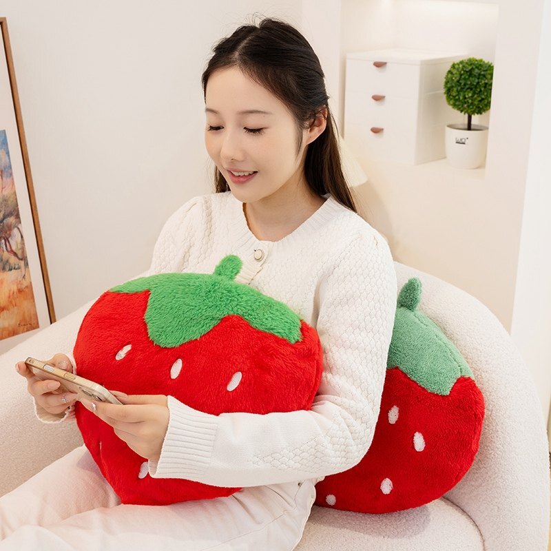Strawberry plush pillows in terry plush and faux rabbit fur fabrics, offering soft comfort for lounging, reading, and everyday relaxation