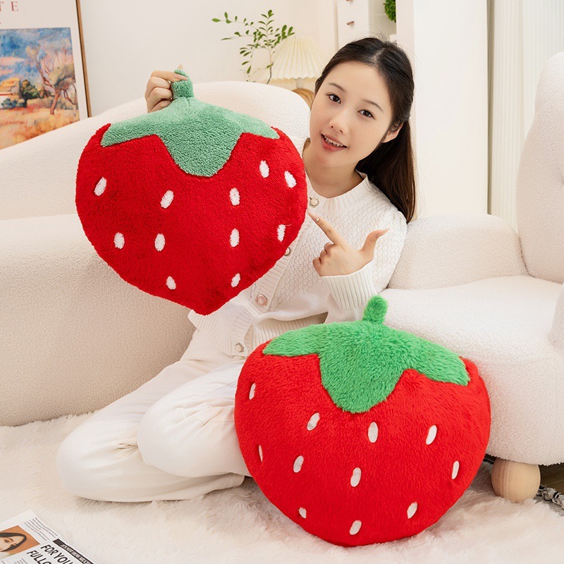 Strawberry plush pillows in terry plush and faux rabbit fur fabrics, adding cozy comfort and playful fruit-inspired charm to sofas and bedrooms
