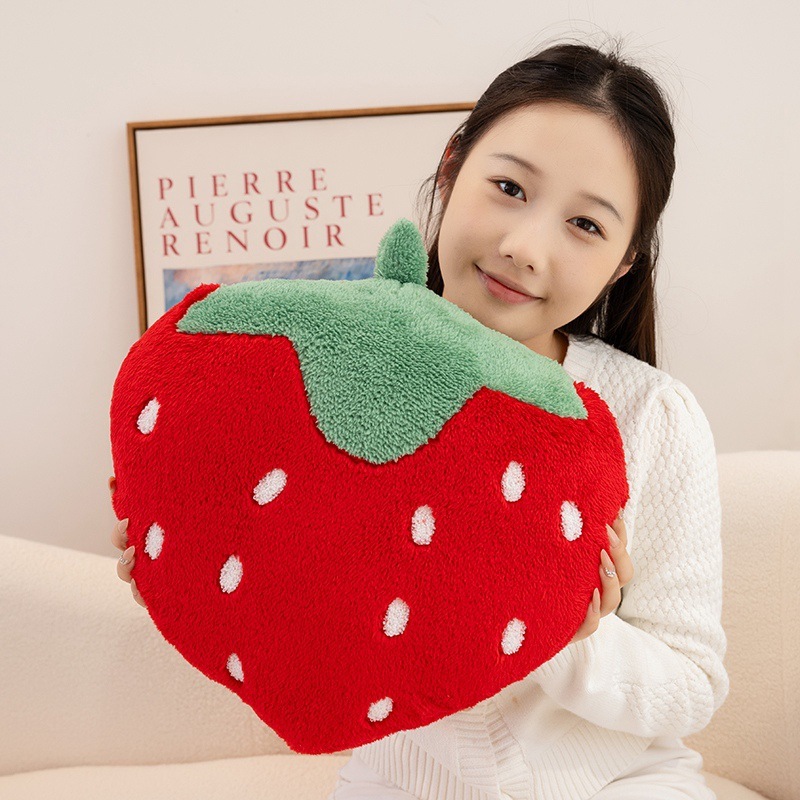 Strawberry plush pillow in terry plush fabric with embroidered seed details, featuring a soft fruit-inspired design for cuddling and decor