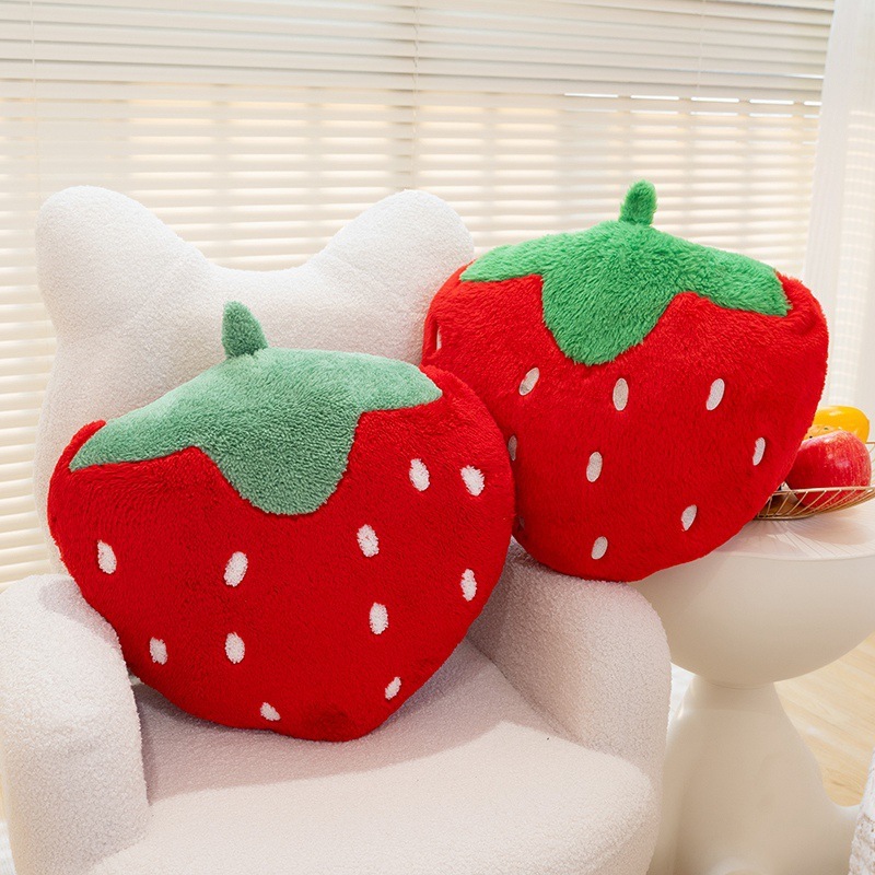 Strawberry plush pillows in terry plush and faux rabbit fur styles displayed on a cozy chair, adding a playful fruit-inspired touch to home decor