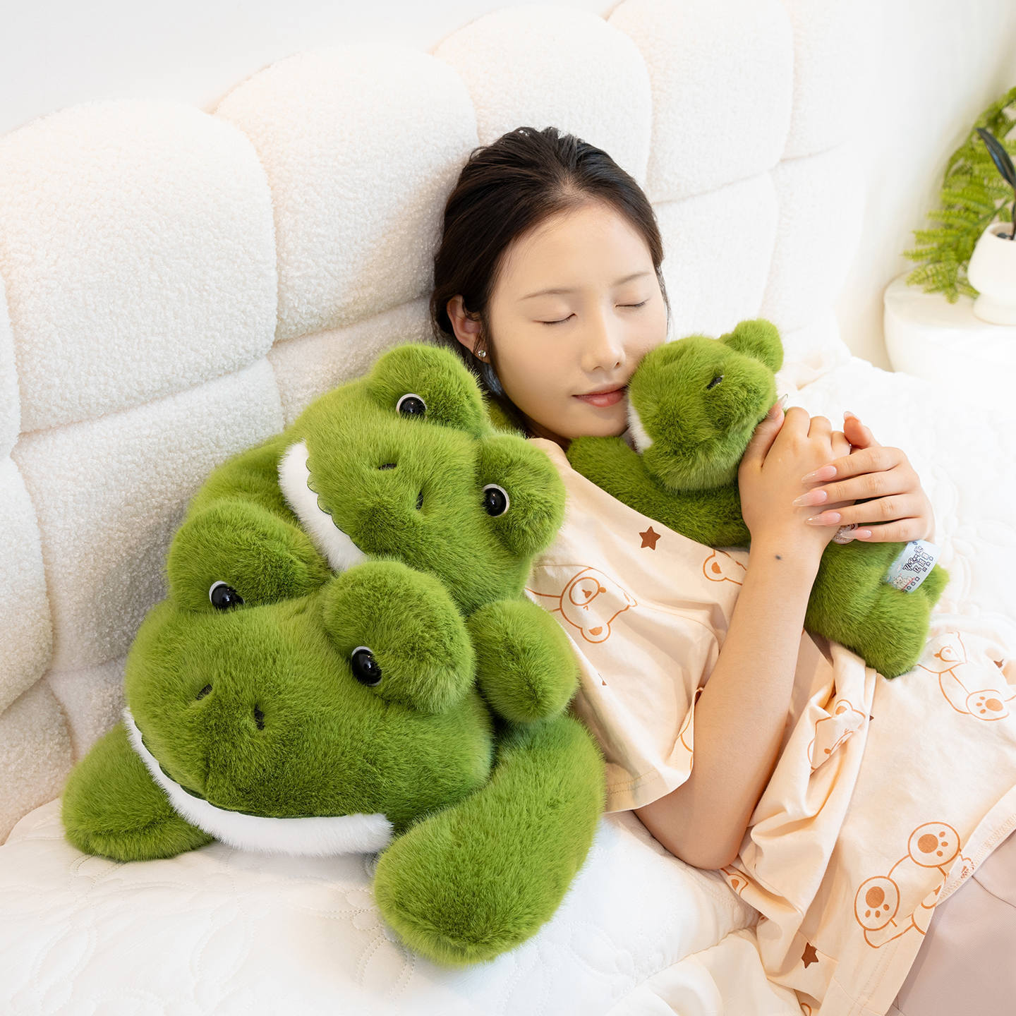 Cute Frog Plush Toy resting on a bed, featuring a soft fluffy texture and adorable lying frog design for cuddling and decor