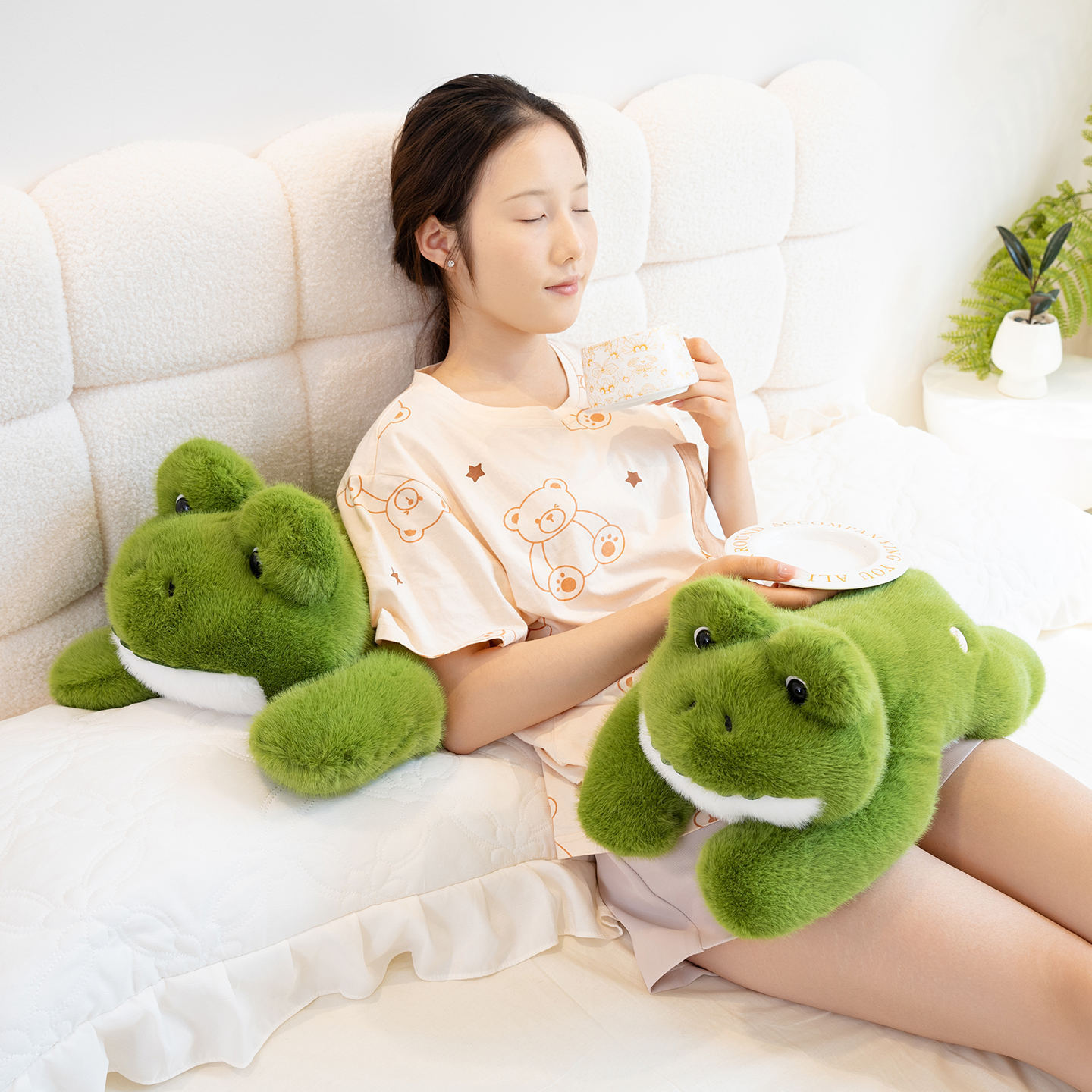 Cute Frog Plush Toy displayed in a cozy bedroom setting, suitable for cuddling, lounging, and decorative use