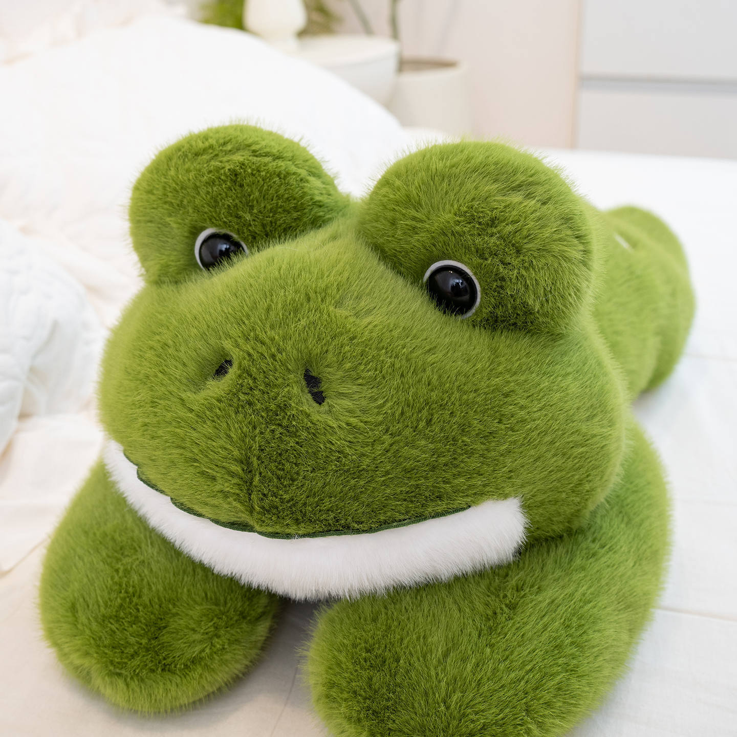 Detailed view of a Cute Frog Plush Toy highlighting its rounded face, plush texture, and charming frog features