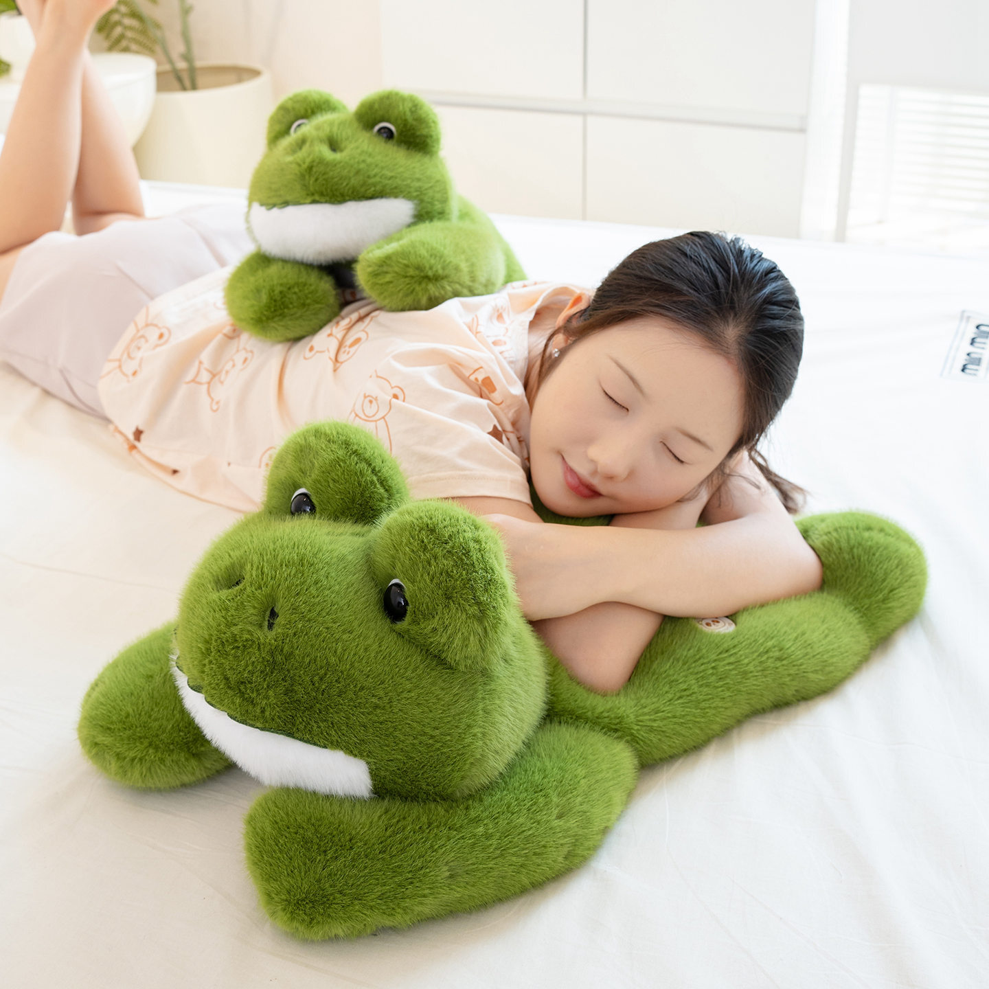 Cute Frog Plush Toy used as a soft pillow on a bed, showcasing a cozy lying frog shape for relaxing and lounging