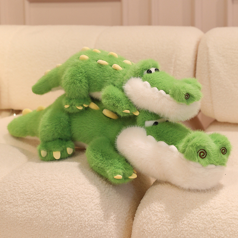 Cute Crocodile Plush Toys stacked together on a sofa, showcasing their cuddly design, embroidered features, and soft plush finish