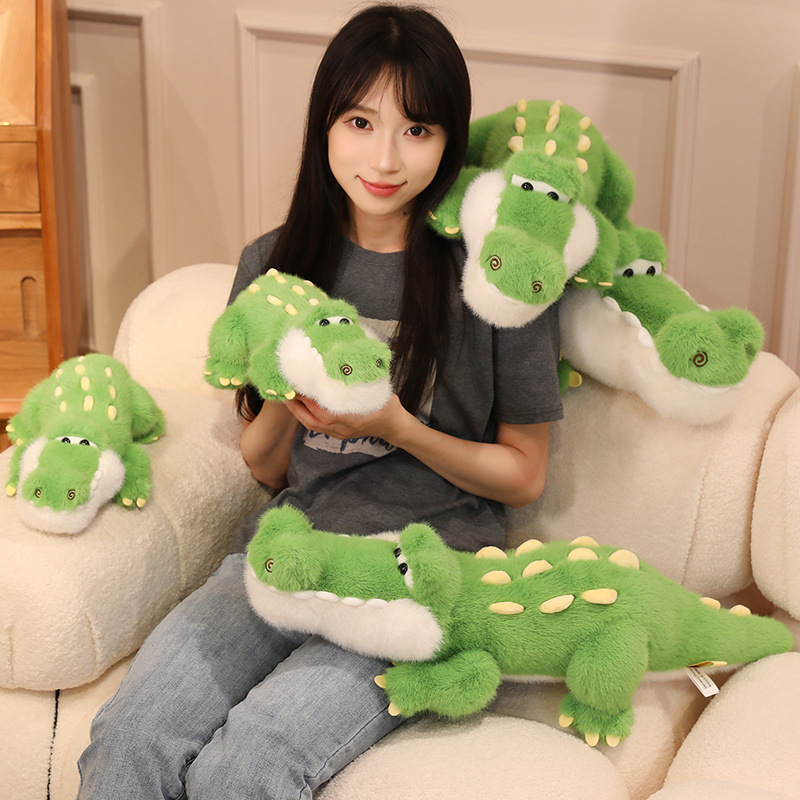 Cute Crocodile Plush Toy displayed in multiple sizes on a cozy sofa, featuring soft plush fabric, playful crocodile details, and a cheerful decorative look