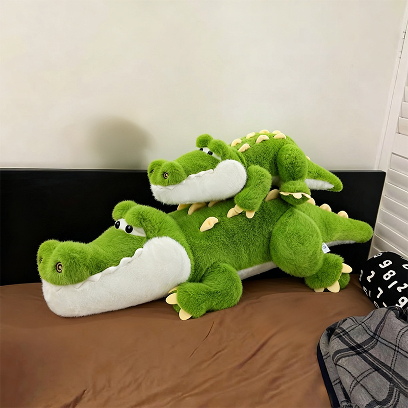 Cute Crocodile Plush Pillows in different sizes styled on a bed, showcasing soft plush texture and charming crocodile details