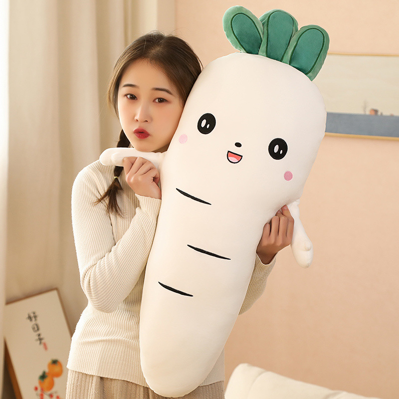 White Carrot Plush Pillow with a smiling embroidered face and leafy top detail, designed for hugging, lounging, and cozy room decor
