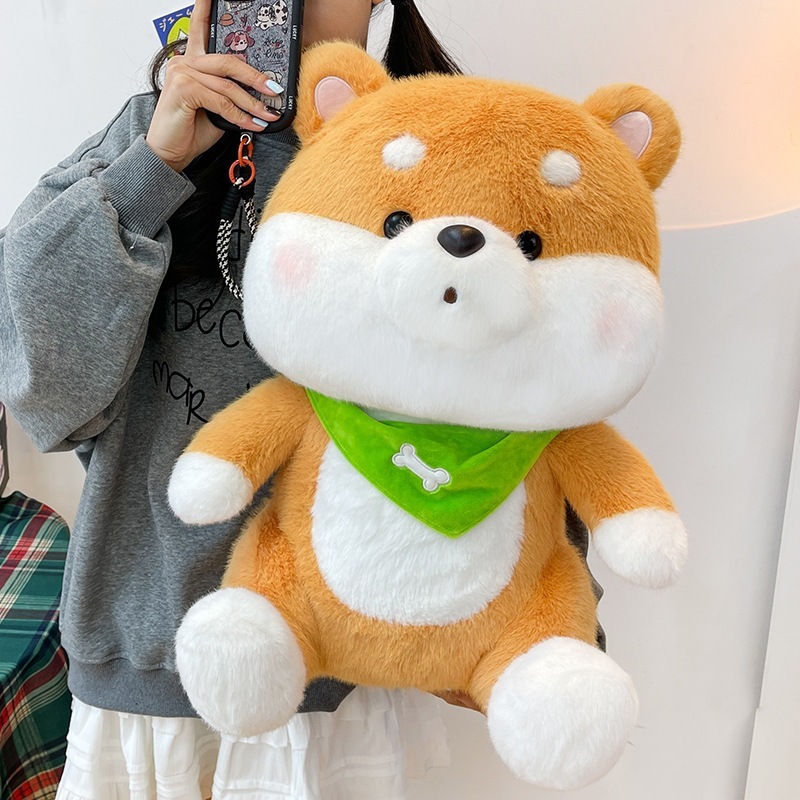 Shiba Inu plush toy with a green bandana featuring fluffy plush fabric, rounded proportions, and a soft huggable design